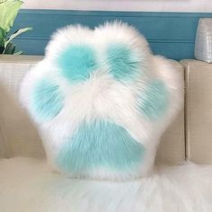 a white and blue pillow sitting on top of a couch