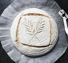 a piece of bread that is on top of a paper plate next to a fork