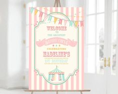 a circus birthday party sign on a easel in front of a white door with pink and green stripes