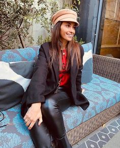 a woman sitting on top of a blue couch