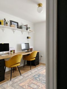 a desk with two computers on it in a room