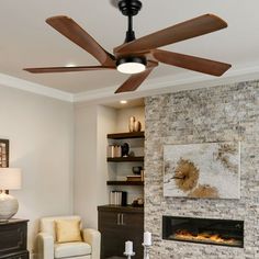 a living room with a fireplace and ceiling fan