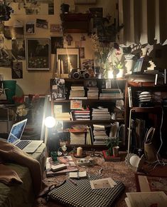 a messy living room filled with lots of clutter and books on top of a wooden floor