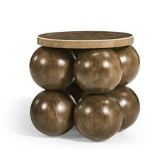 a wooden table with four balls stacked on top