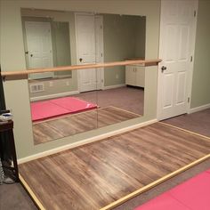 an empty room with mirrors and yoga mats