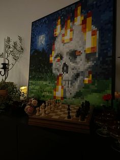 a chess board with a skull on it in front of a large pixel art piece