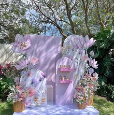 a pink and white display with flowers on it