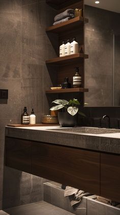 a bathroom sink sitting under a mirror next to a shelf