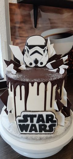 a star wars themed cake with chocolate icing and stormtrooper decorations on top