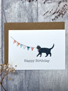 a birthday card with a black cat and bunting flags on the string that says happy birthday