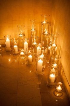 many lit candles are placed on the floor