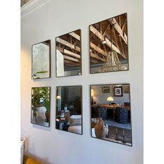 four mirrors hanging on the wall above a couch