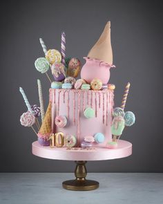 a pink cake decorated with candy and candies