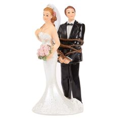 a wedding cake topper with a bride and groom