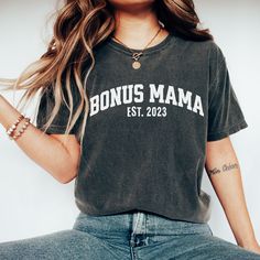 "Welcome to the coolest club in town: the Bonus Mamas Club! If you're a proud bonus mother or you know someone who is, this retro and wavy \"Bonus Mama Club\" t-shirt is the perfect way to show it off in style. Crafted from soft and comfortable fabric, this t-shirt features eye-catching text that celebrates the unique bond between bonus moms and their stepchildren. The retro and wavy font gives it a trendy and fun look that's perfect for wearing on any occasion. Whether you're looking for a gift Relaxed Fit Tops With Lettering For Mother's Day, Short Sleeve Tops With Lettering For Mother's Day, Mother's Day Graphic Tee Soft-washed, Step Mom Shirts, Cricut Clothes, Wavy Font, Mama Sweater, Step Mom Gifts, Mom Sweater