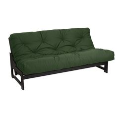 a green futon sofa bed sitting on top of a wooden frame