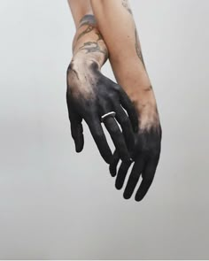 a person with black and white paint on their hands