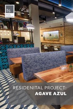 a restaurant with wooden tables and blue chairs in front of the counter top is an advertisement that reads residential project agave azul