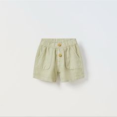 Shorts With Elastic Waistband And Front Button Appliqu. Front Pockets And Back Patch Pockets. Fabric Is 55% Linen. Size 3-4 Years Light Green Green Shorts With Pockets For Playwear, Cotton Shorts With Buttons, Short Cotton Pants With Button Closure, Cute Summer Pants With Pockets, Green Bottoms With Pockets For Playwear, Green Summer Bottoms With Buttons, Casual Cotton Shorts With Buttons, Spring Playwear Shorts With Pockets, Cute Playwear Shorts With Pockets