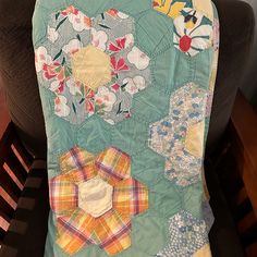 the back of a chair with a quilt on it