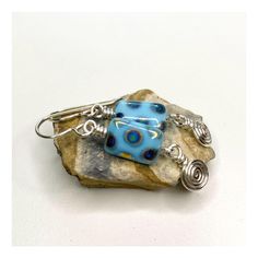 Turquoise blue rectangular, Czech glass beads have splashes of iridescent, metallic rainbow!  I paired these gorgeous beads off with silver swirl dangles, hand wrapped by me, in my studio. The movement makes these so much fun to wear!  Due to hand crafting, please expect minor differences.  Light weight and comfortable enough to wear everyday.  Finished with my .925 Sterling Silver ear wires.  Earrings hang approximately 1 1/2", including earring wires.  Lead and nickel free. Perfect for those who love unique, vintage style. All Lintuni jewelry is hand made in Historic Nazareth, PA, USA and comes lovingly gift packaged as a treat for yourself or a special someone. Return to Lintuni here   www.etsy.com/shop/Lintuni Shipping :: Ground Advantage USPS with Tracking Please read my policies and Nickel-free Spiral Blue Earrings, Pumpkins Crafts, Diy Pumpkins Crafts, Diy Pumpkins, Handmade Silver Earrings, Metallic Rainbow, Swirl Earrings, Earring Wires, Silver Earrings Handmade