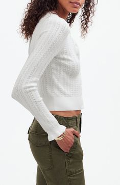 This cozy button-front cardigan comes in Madewell's soft, lacy semi-open Signature Knit. With a flattering slim fit, it has ruffled cuffs that add a playful finishing touch. 20 1/2" length Front button closure Crewneck Long sleeves 72% Lenzing™ EcoVero™ viscose, 28% polyester Lenzing EcoVero viscose is a more-sustainably produced fiber made using pulp made from renewable wood sources Machine wash, tumble dry Imported Fall Pointelle Knit Button-up Tops, Spring Fitted Textured Knit Cardigan, Spring Textured Knit Fitted Cardigan, Feminine Fitted Cardigan For Daywear, Casual Fitted Pointelle Knit Cardigan, Feminine Pointelle Knit Cardigan For Fall, Fitted Casual Cardigan With Pointelle Knit, Fitted Pointelle Knit Cardigan For Fall, Fitted Textured Knit Cardigan