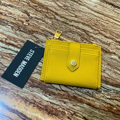 Brand: Steve Madden Color: Mustard Yellow Size: 4 3/4” (W) X 1/2” (D) X 3 3/4” (H) Approx Closure: Snap, Zipper Front Cardholders Back Cardholders Gold Metal Details Material: Saffiano Leather Scratch Resistant, Very Durable, Can Repel Water And Stains, And Easy To Clean. Condition: Brand New With Original Tags Same Day Shipping Via Usps Steve Madden Mustard Yellow Snap Cardholder Wallet Saffiano Leather Trendy Yellow Wallet For Daily Use, Trendy Yellow Wallets For Everyday Use, Trendy Yellow Wallet For Everyday Use, Yellow Casual Wallet For Everyday Use, Yellow Wallet For Everyday Use, Steve Madden Wallet, Cardholder Wallet, Branded Wallets, Brown Leather Wallet