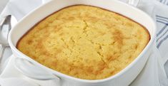 a close up of a casserole dish on a napkin with a spoon in it