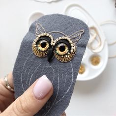 a person holding up a cell phone case with an owl design on it