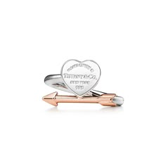 Inspired by a key ring we debuted in 1969, the Return to Tiffany® collection is famous for its signature motif. This sterling silver ring features the iconic heart tag with an 18k rose gold arrow for a perfect pairing. Wear on its own or stacked with rings in a mix of metals. Sterling silver and 18k rose gold; Motif size, mini | Return to Tiffany® Lovestruck Heart Tag Ring in Silver and Rose Gold, Size: 7 1/2