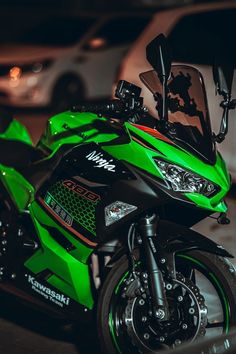 a green and black motorcycle parked on the street