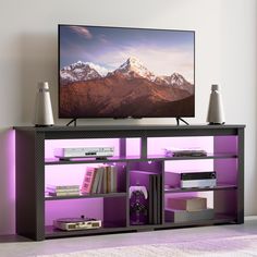 a flat screen tv sitting on top of a purple shelf