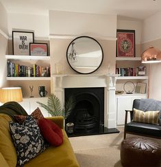 a living room filled with furniture and a fire place next to a wall mounted clock