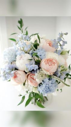 a bouquet of blue and white flowers in a vase