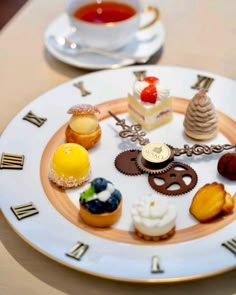 a white plate topped with lots of different types of pastries on top of a table