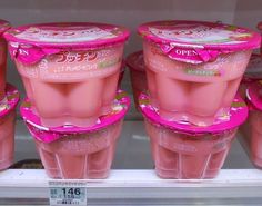 pink yogurt cups are on display in a store