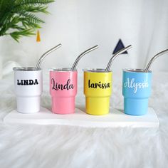 three personalized tumblers with straws in them on a white furnishing