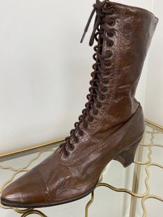 Classic dark brown leather lace up granny boots. Pristine condition! Please see further details below. Label - AHM System Made in Canada Leather with stacked heel Labelled as size 6. Should fit a size 5.5 or a narrow size 6 but please refer to measurements below as I am unable to offer returns. Please remember these are vintage and may be slightly narrower than today's sizing standards.  2" heel 10" tall  Widest part of exterior sole is approximately 3"  Exterior sole length 10.5 " approximately Granny Boots, Victorian Lace, Vintage Boots, Lace Up Ankle Boots, Dark Brown Leather, Leather Lace, Stacked Heel, Brown Boots, Boot Shoes Women