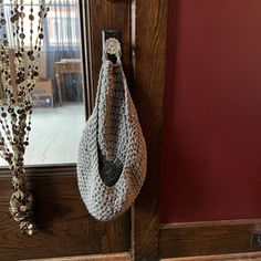 a crocheted bag hanging on a door handle