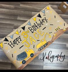 the birthday cake is decorated with yellow and black cars on it's side,