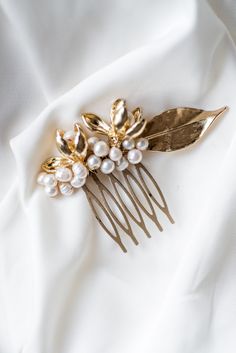 Modern bride needs a modern hair piece. And this hair comb is a perfect accessory to wear. It is made with freshwater pearls and gold metal flowers and leaf. It looks elegant and stunning. Ideally, wear it in an updo. Secure with bobby pins if needed.  All of my products are handcrafted. They appear as individual pieces and thus are unique and one of a kind. Every product is created when I feel passion and inspiration to make something new. I'd be more than pleased to see my little treasures as Pearls Wedding Hair, Bridal Hair Combs Pearl, Pearl Hair Combs, Pearls Wedding, Gold Hair Accessories, Flower Comb, Wedding Hair Clips, Modern Bridal, Head Hair