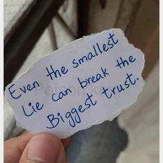 someone holding up a piece of paper that says even the smallest lie can break the biggest trust