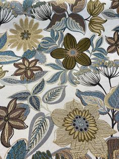 a close up view of an area rug with flowers and leaves on it