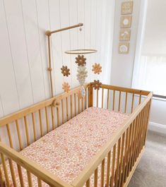 a wooden crib with a pink blanket on it