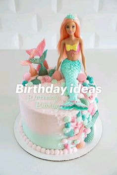 a birthday cake with a mermaid doll on top