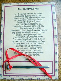 the christmas nail poem is laying on top of a table with a red ribbon tied around it