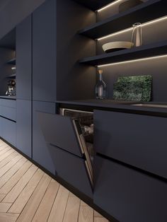 an open cabinet in the middle of a kitchen with wooden flooring and blue cabinets