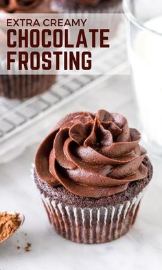 chocolate frosted cupcakes with extra creamy chocolate frosting on top and in the background