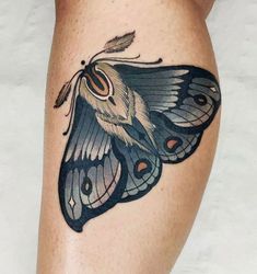 a close up of a butterfly tattoo on the leg