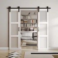 an open sliding door in a living room with bookshelf and couch behind it